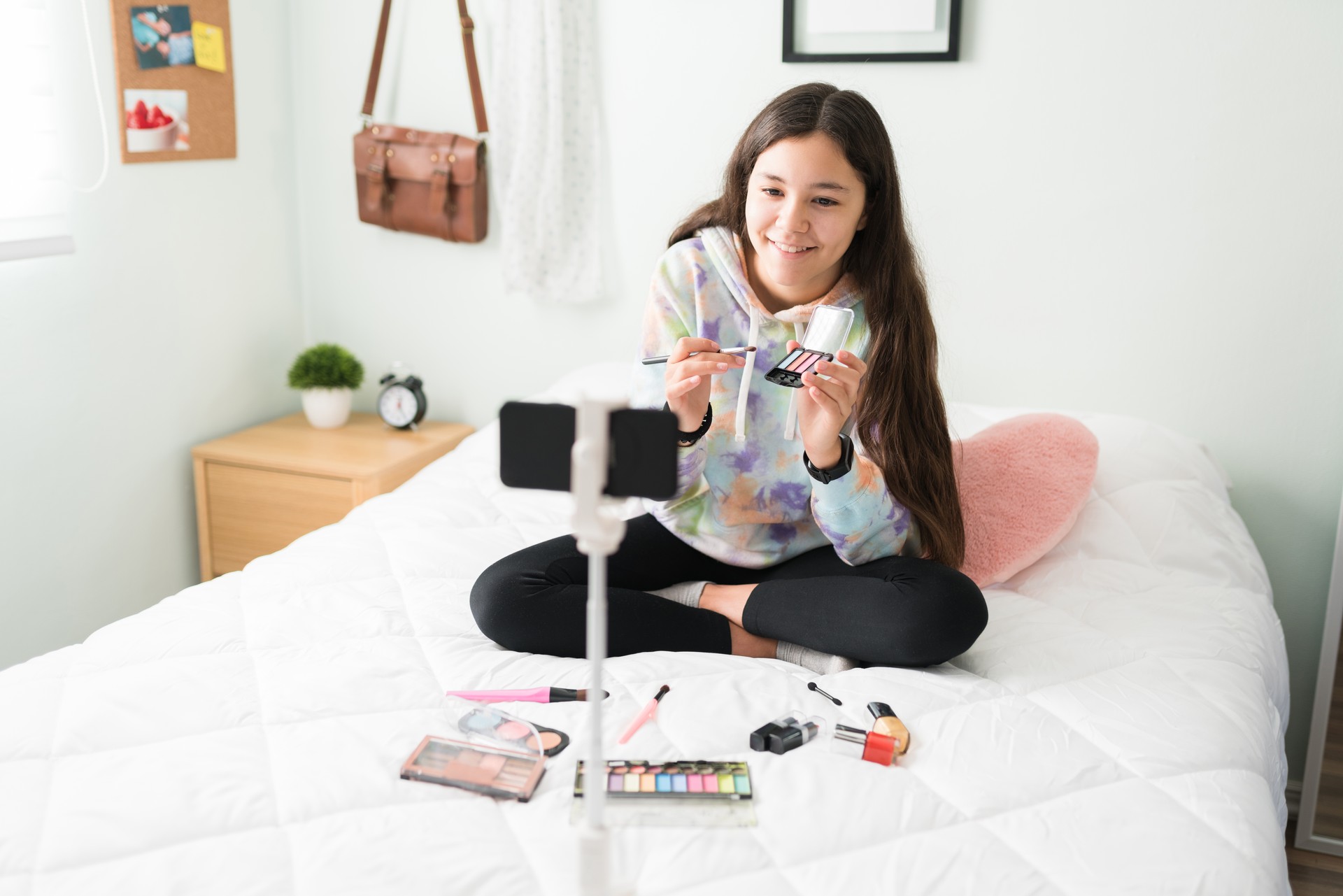 Beautiful teen influencer using makeup for a new vlog